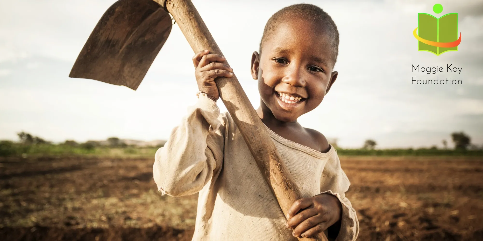 A child holding a garden tool, pictured with the Foundation’s earlier logo.